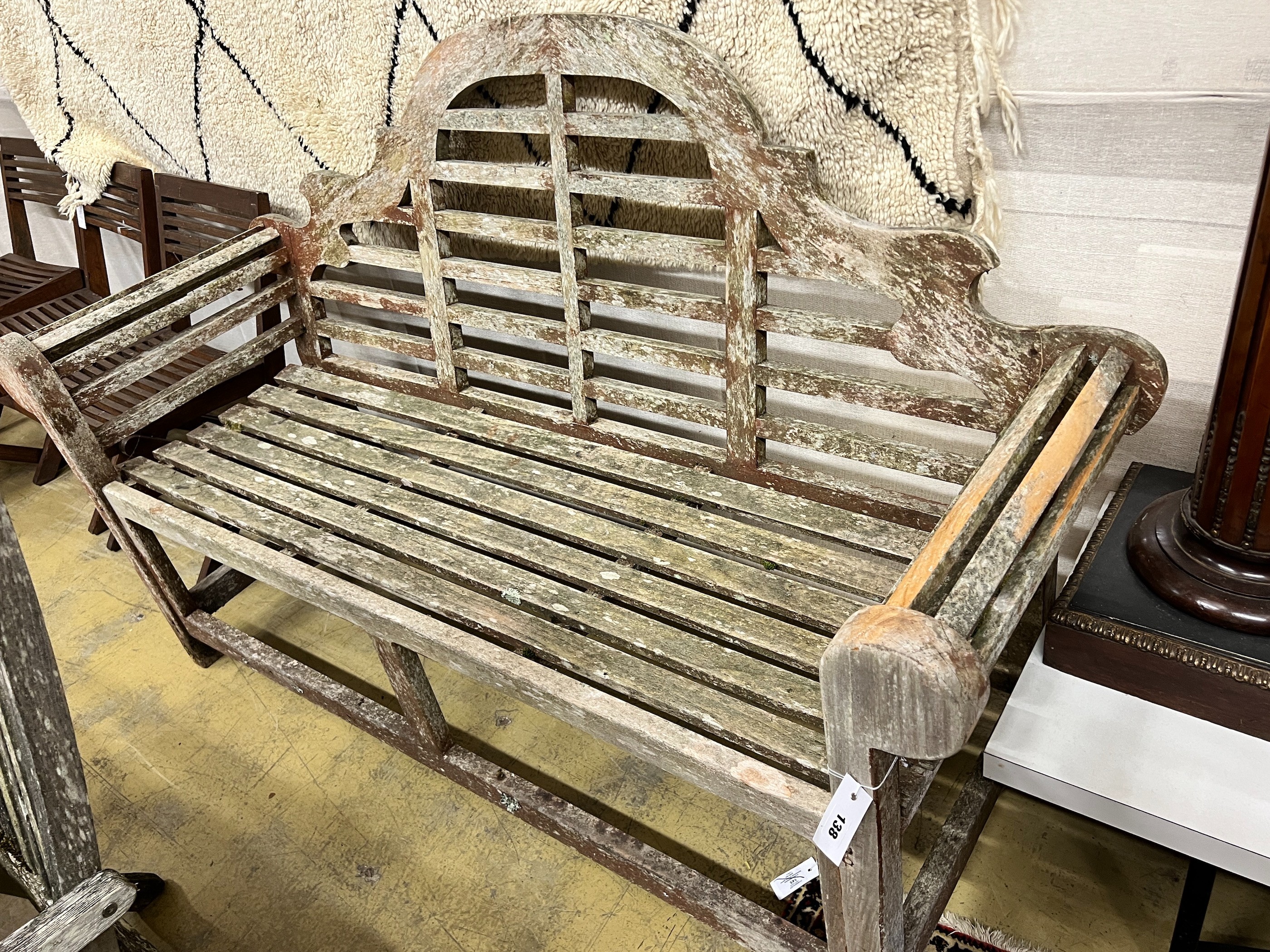 A Lutyens style weathered teak garden bench, length 164cm, depth 56cm, height 103cm